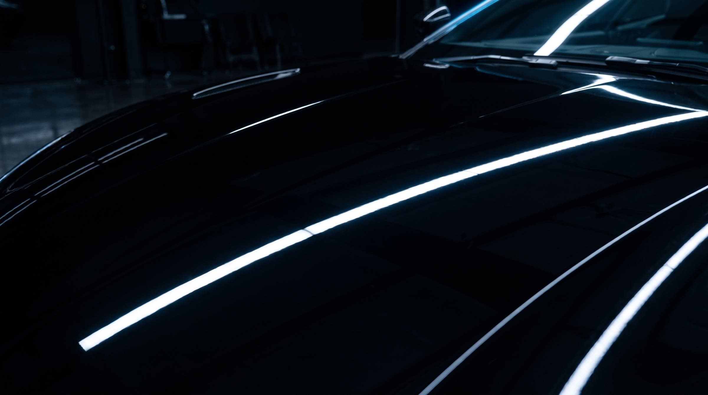 The corrected hood: deep black paint with one sharp reflected light line